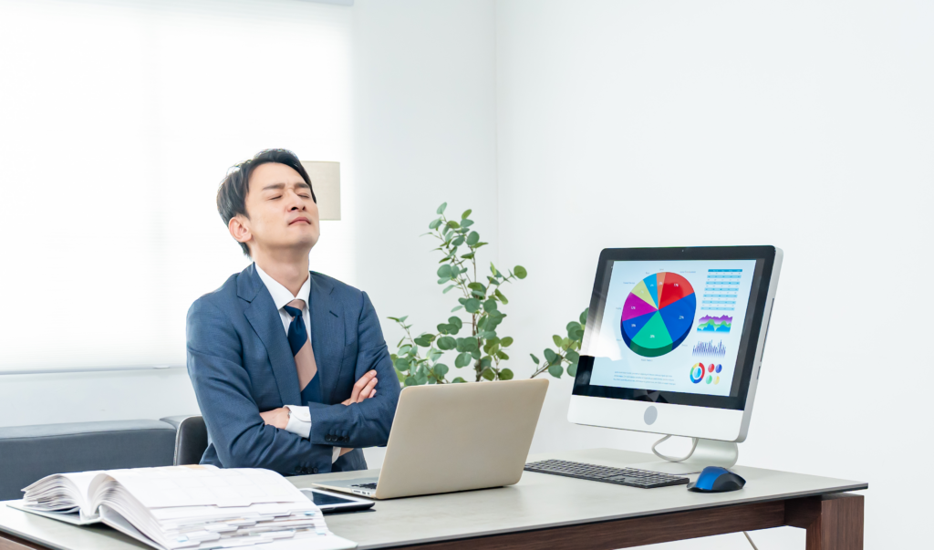 仕事中に机で閉じる男性