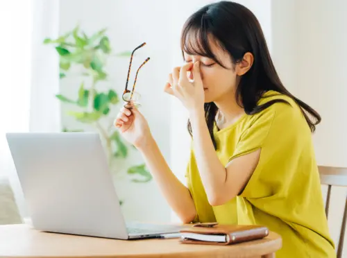 パソコン作業中に疲れを感じている女性